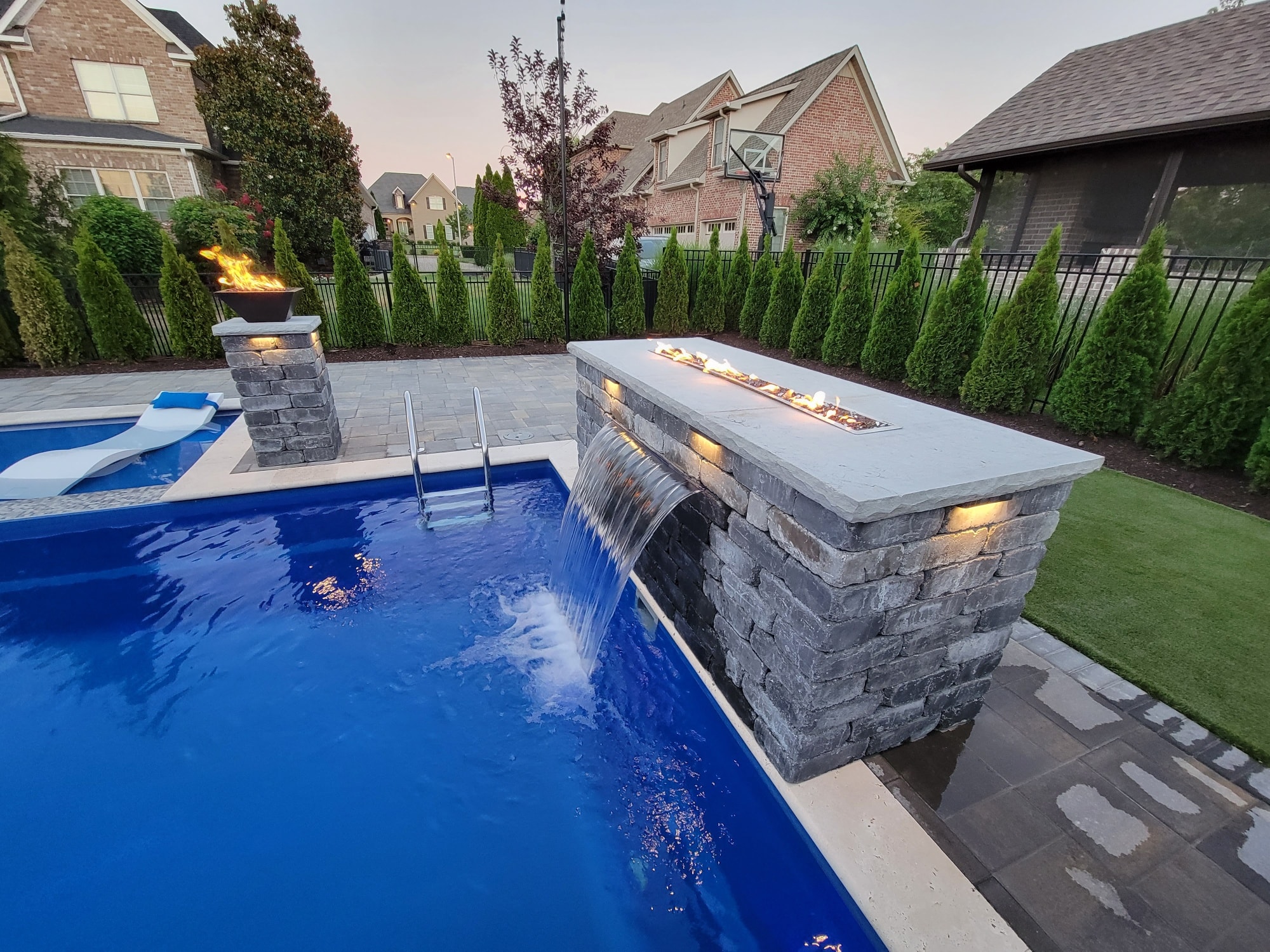 pool waterfall with fire feature
