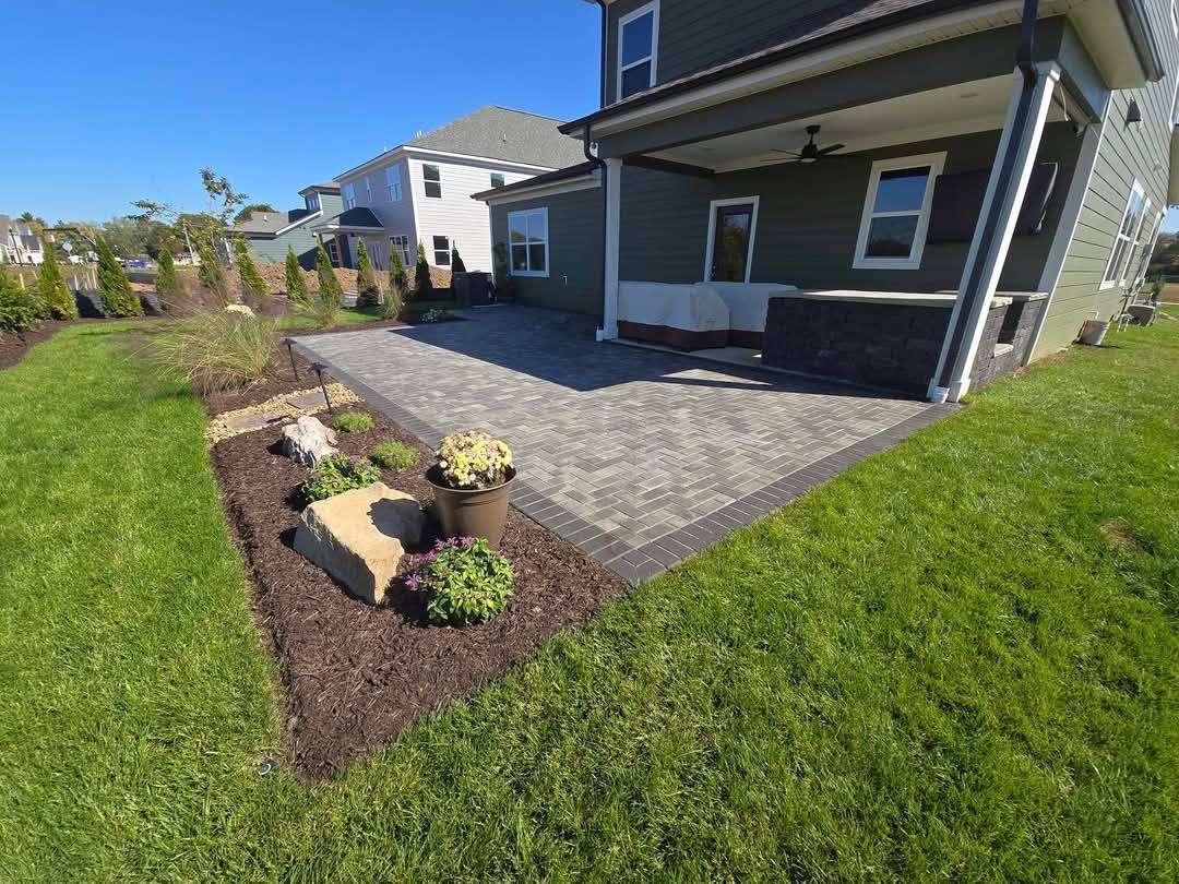 patio surrounded by flower beds