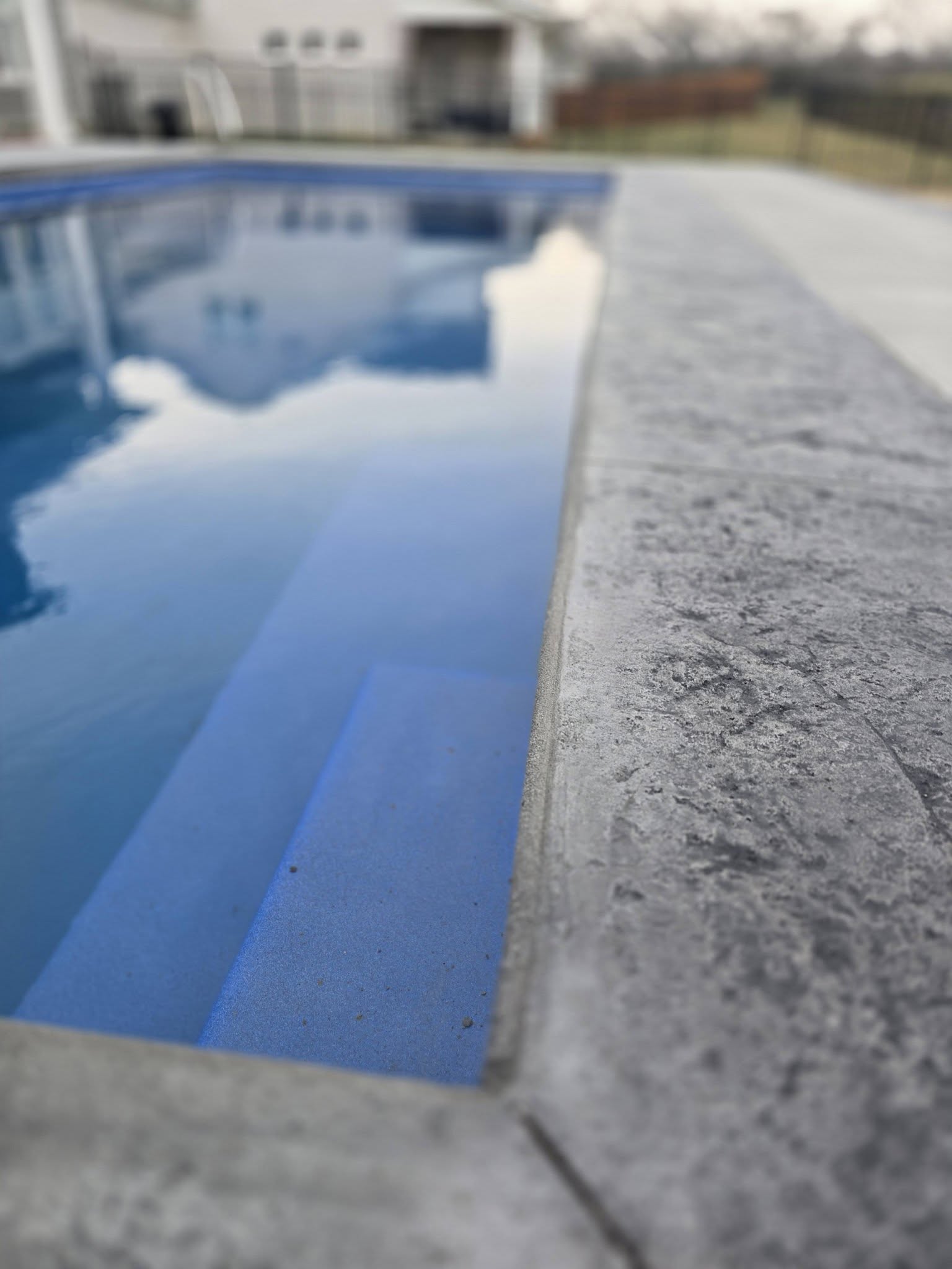 pool with stamped concrete surrounding