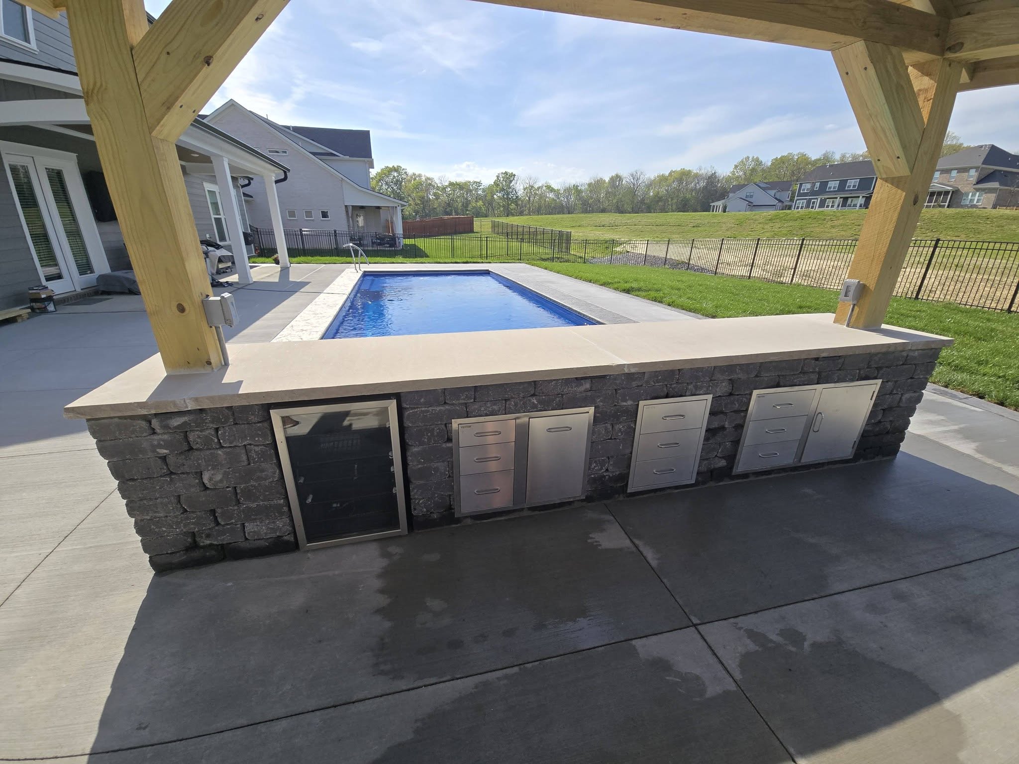outdoor kitchen next to pool